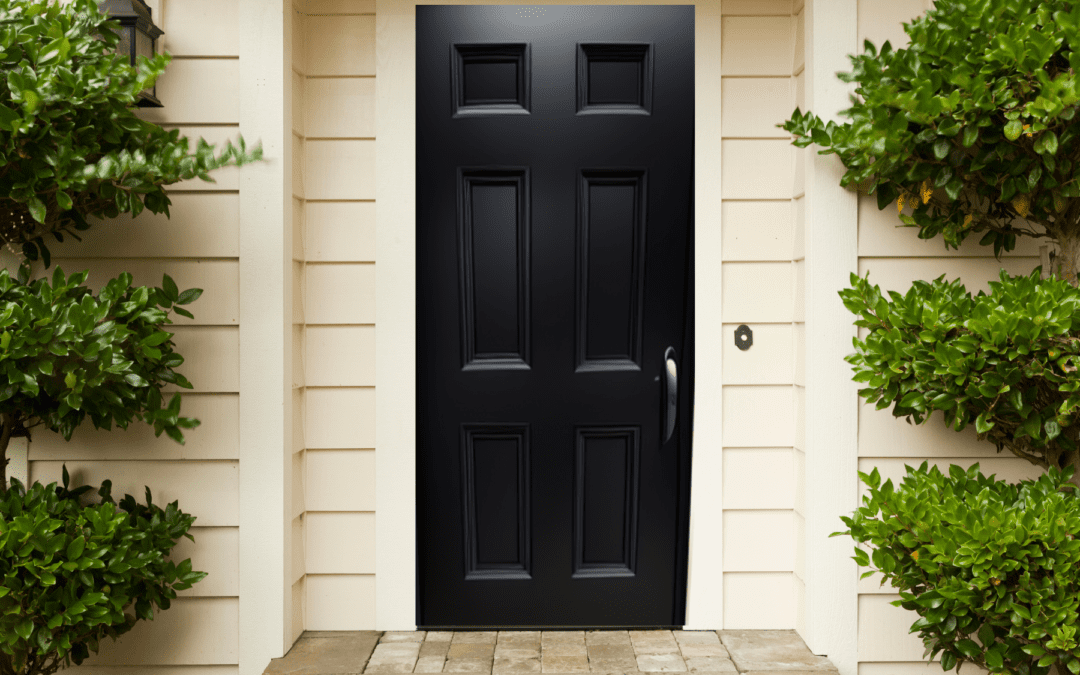 Steel door with intricate design resembling tree branches on either side, blending seamlessly with the natural environment